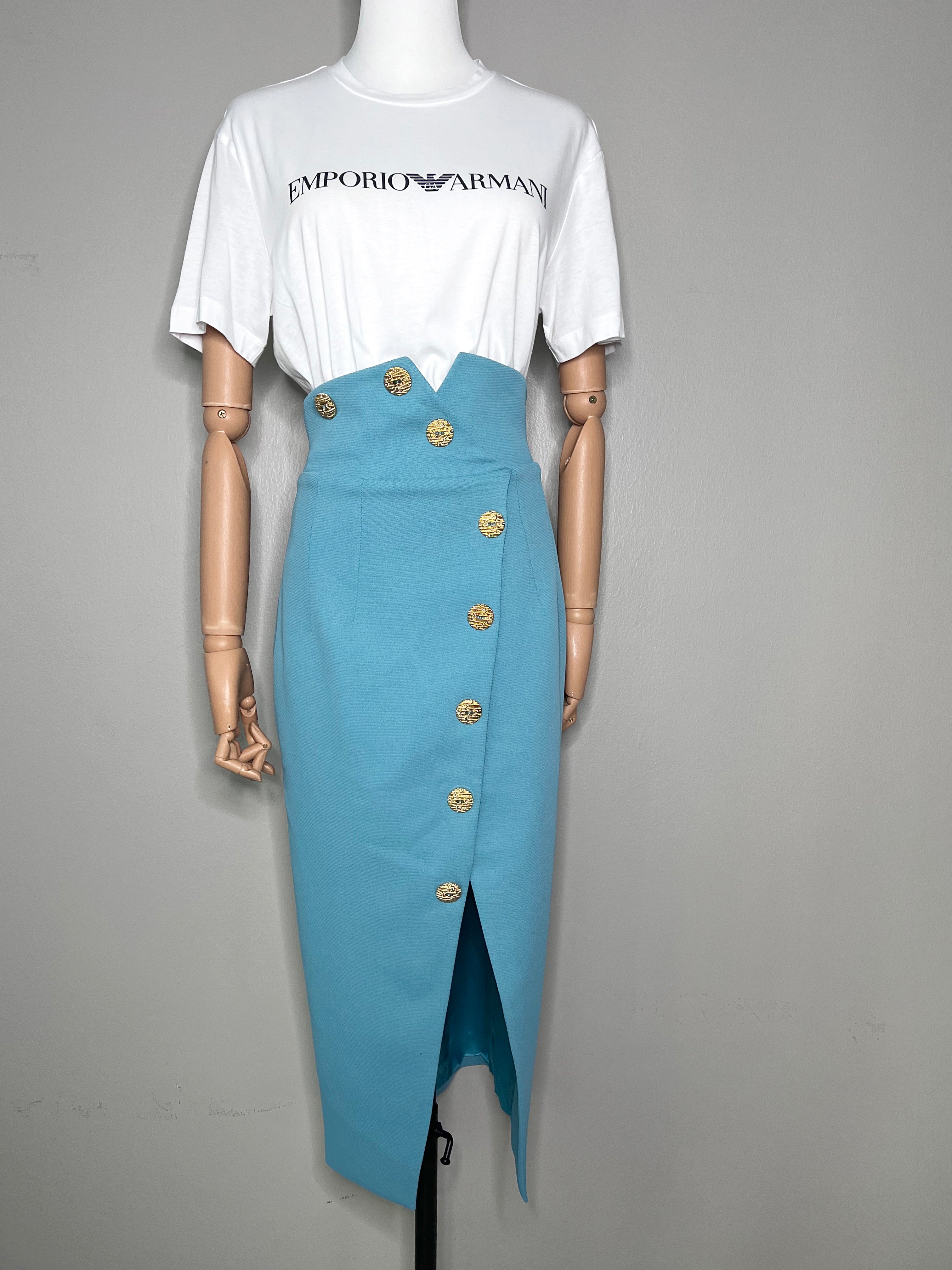 Long sky blue skirt with slit at the middle and big gold buttons all the way down and on the waistline. - GLAMODA.