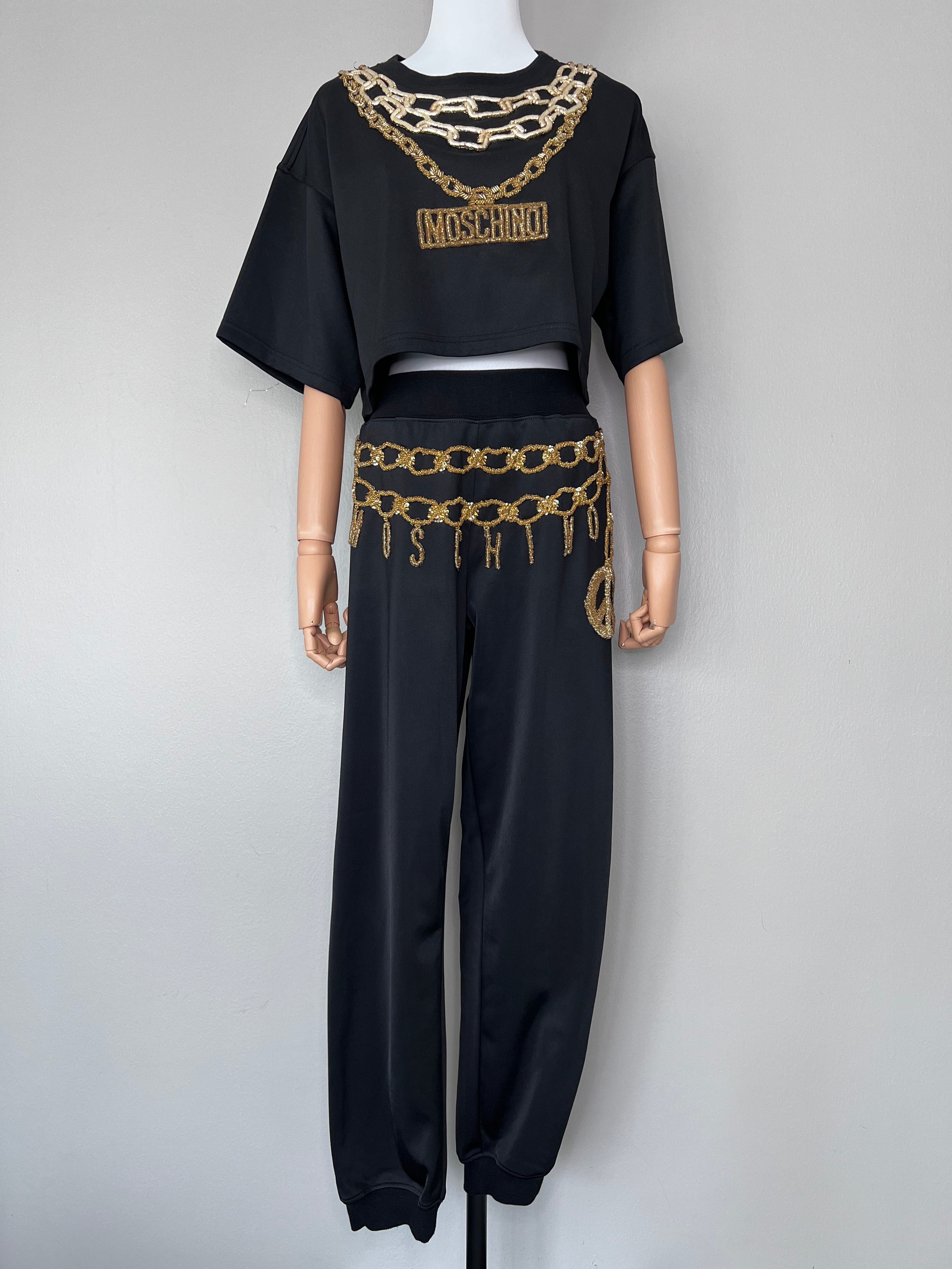 A set of Mid waist black joggers with gold beading along the front and