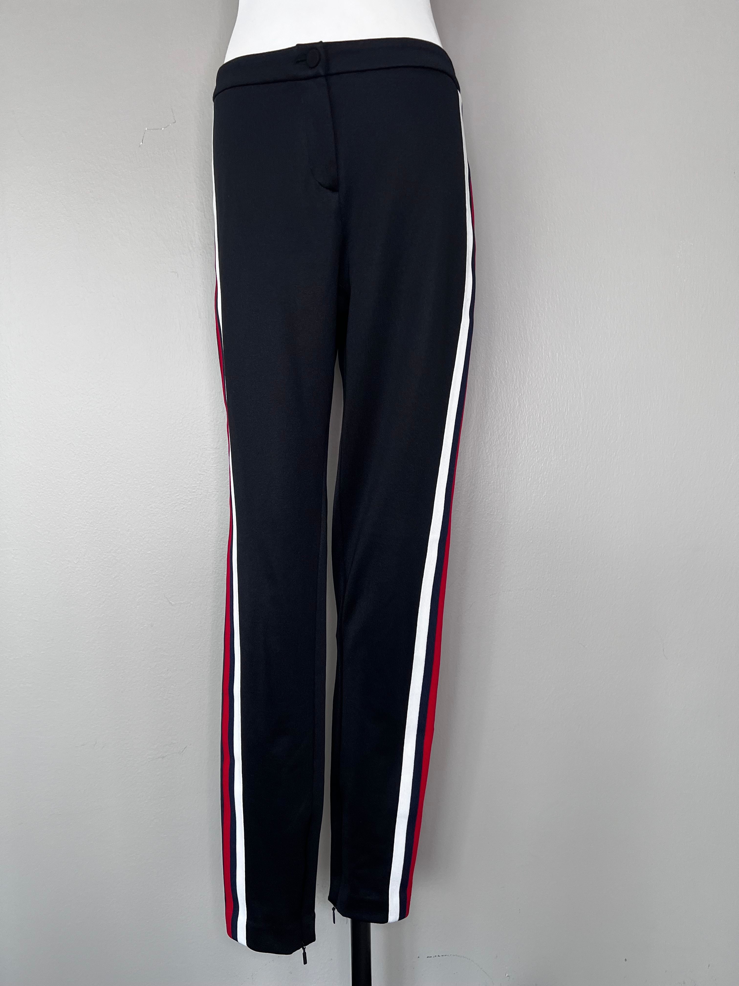 Black straight leg Guccci joggers with red, blue, and white stripes on the sides.