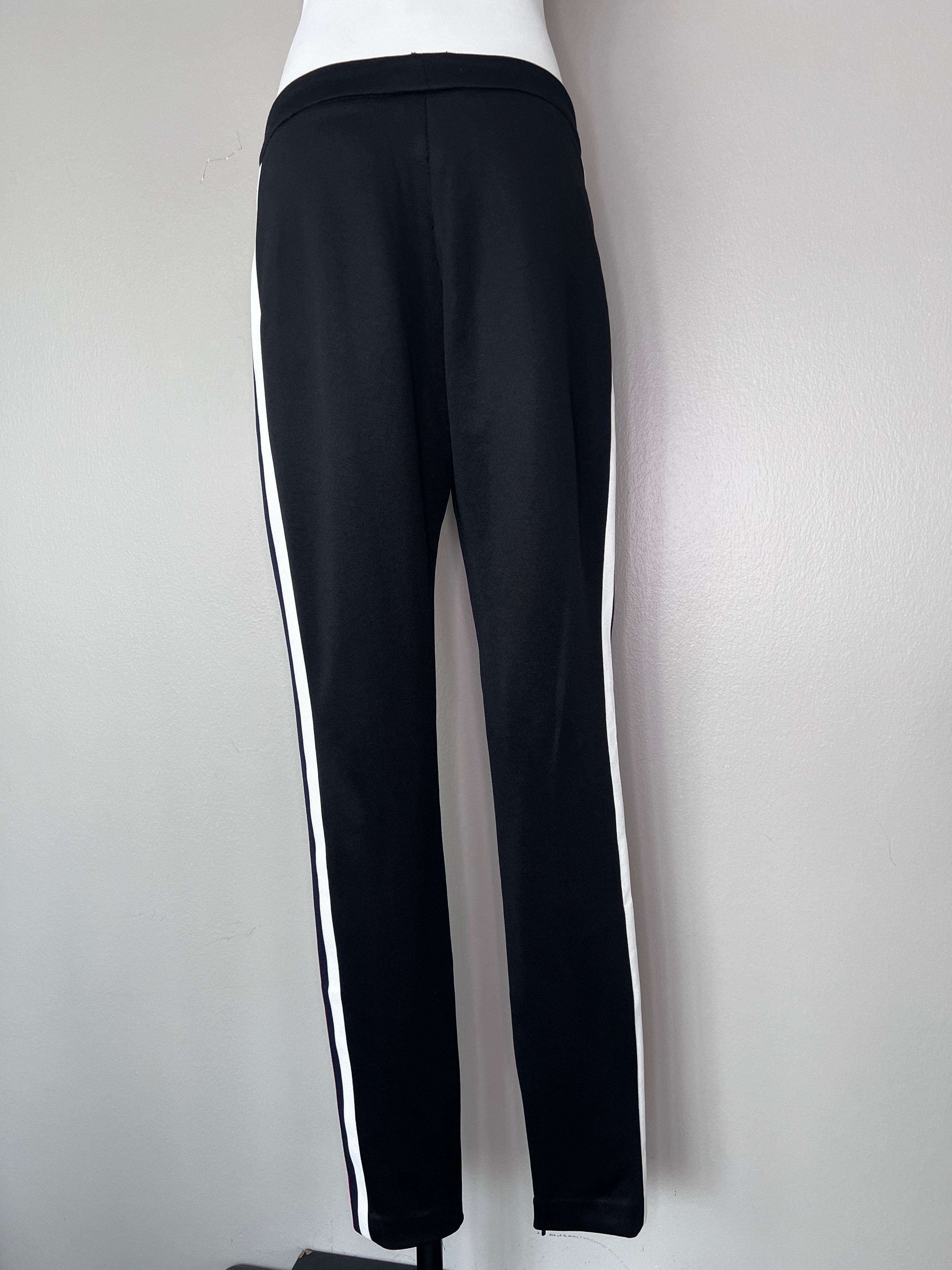 Black straight leg Guccci joggers with red, blue, and white stripes on the sides.