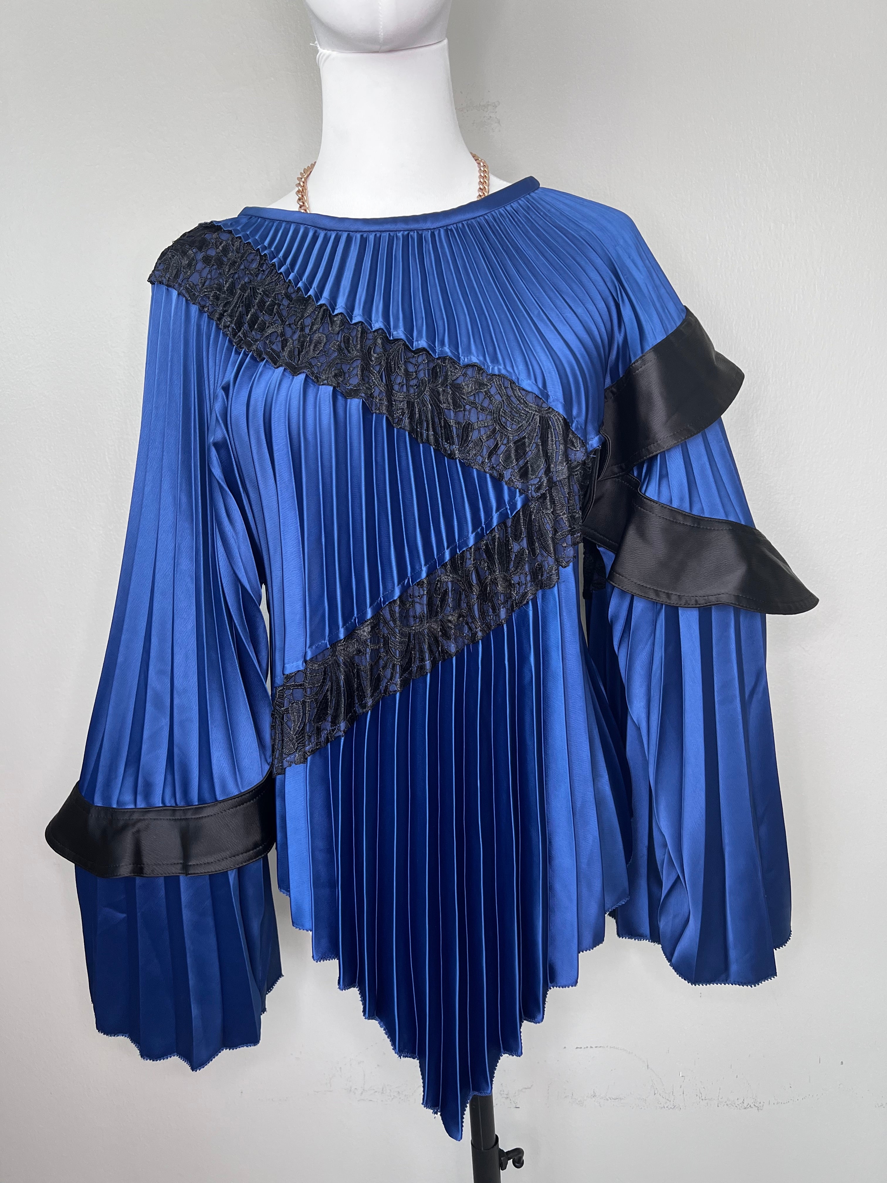 Blue chic top with black mesh pattern across flowy sleeves and gold chain around neck - SELF-PORTRAIT