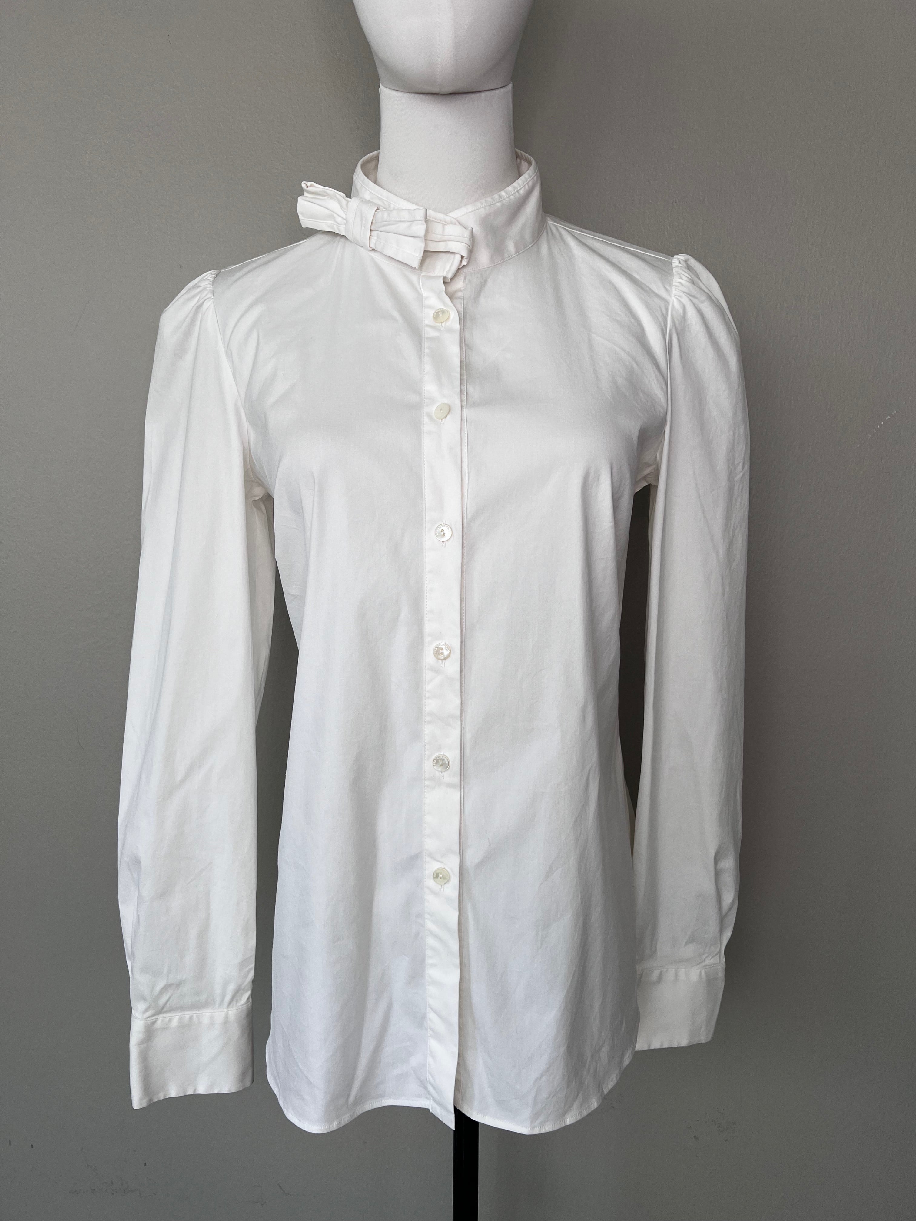 White cotton button-down blouse with bow detailing at collar.- RED VALENTIINO