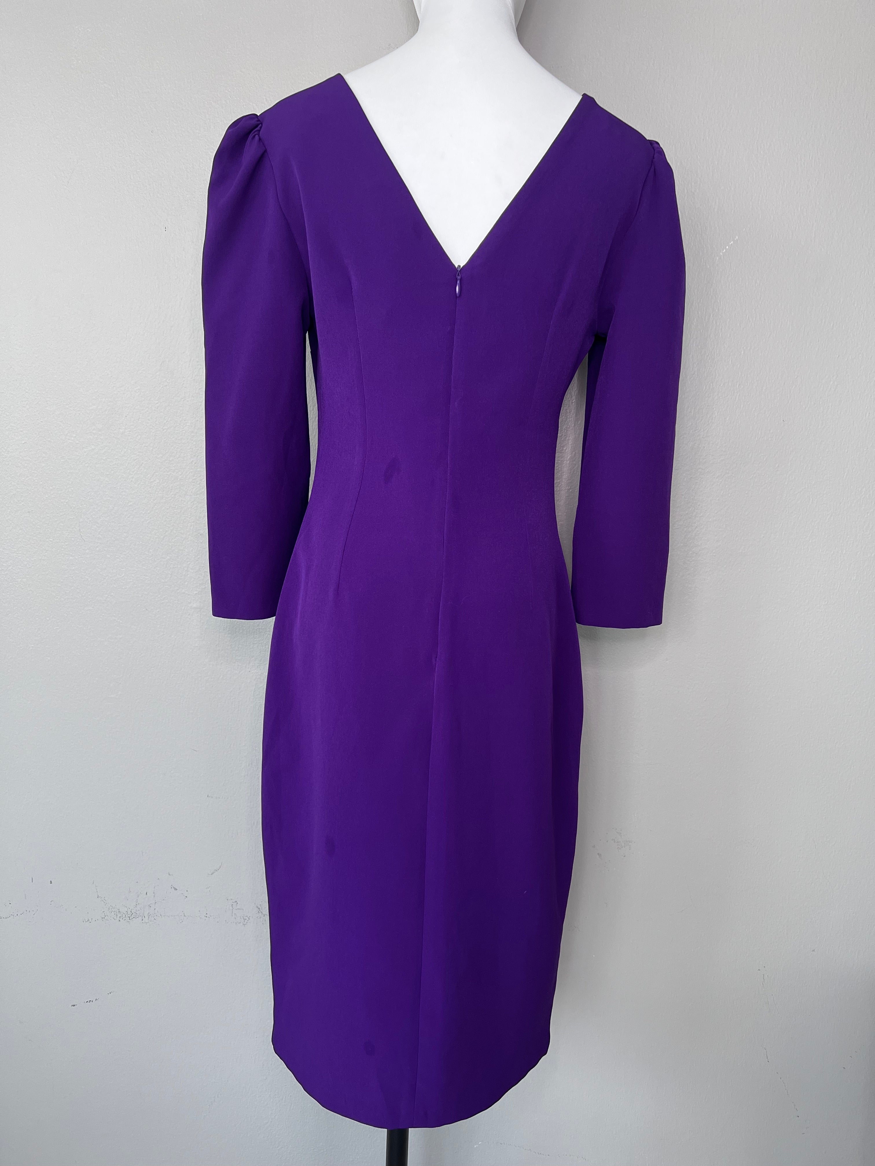 Brand new. Longsleeve purple dress with keyhole neckline and pinlike designs connecting the hole back together.- ALMAGORES