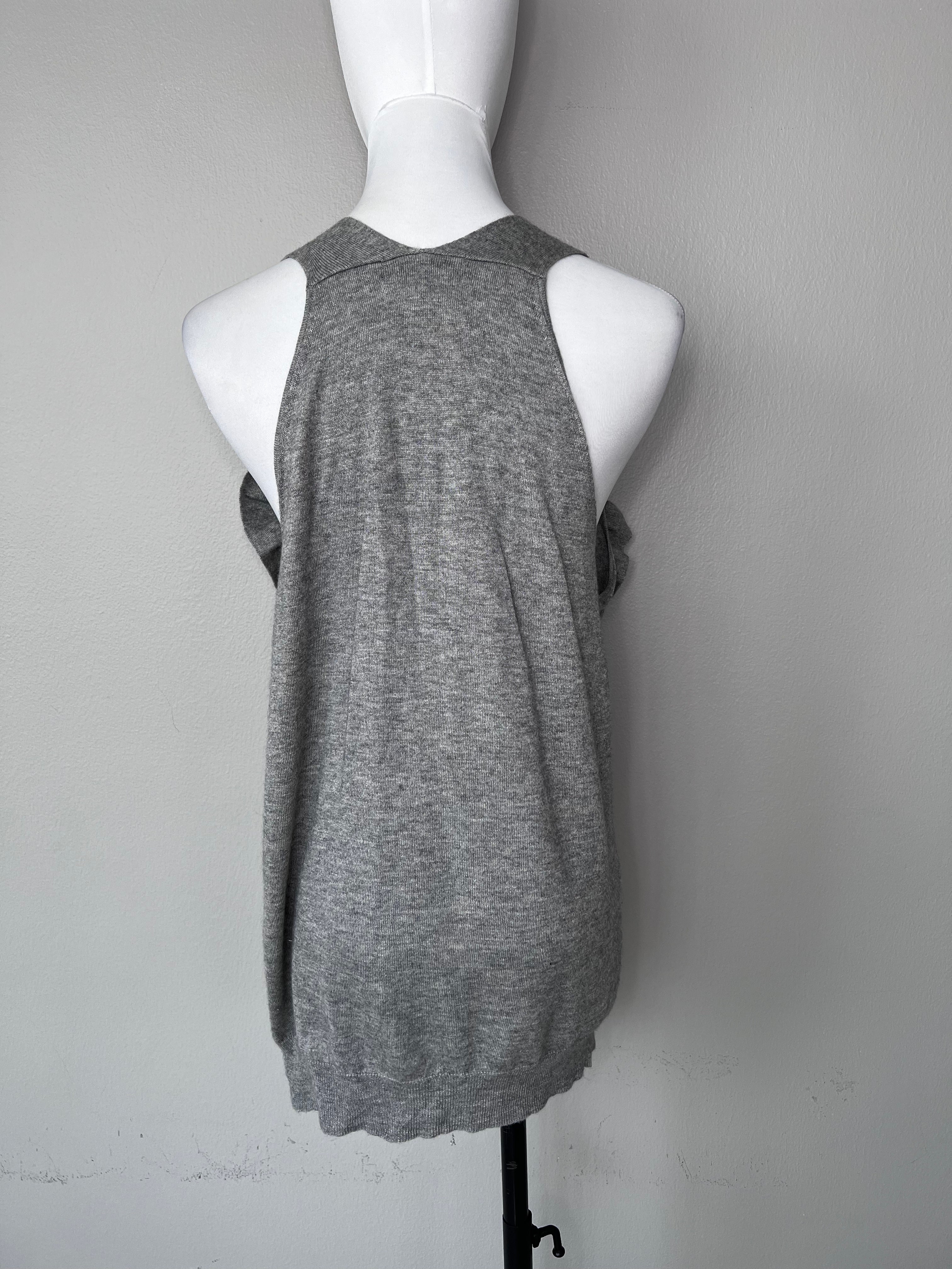 Grey cashmere tank top with big buttons going down and flowy detailing at the neckline. - MAJE
