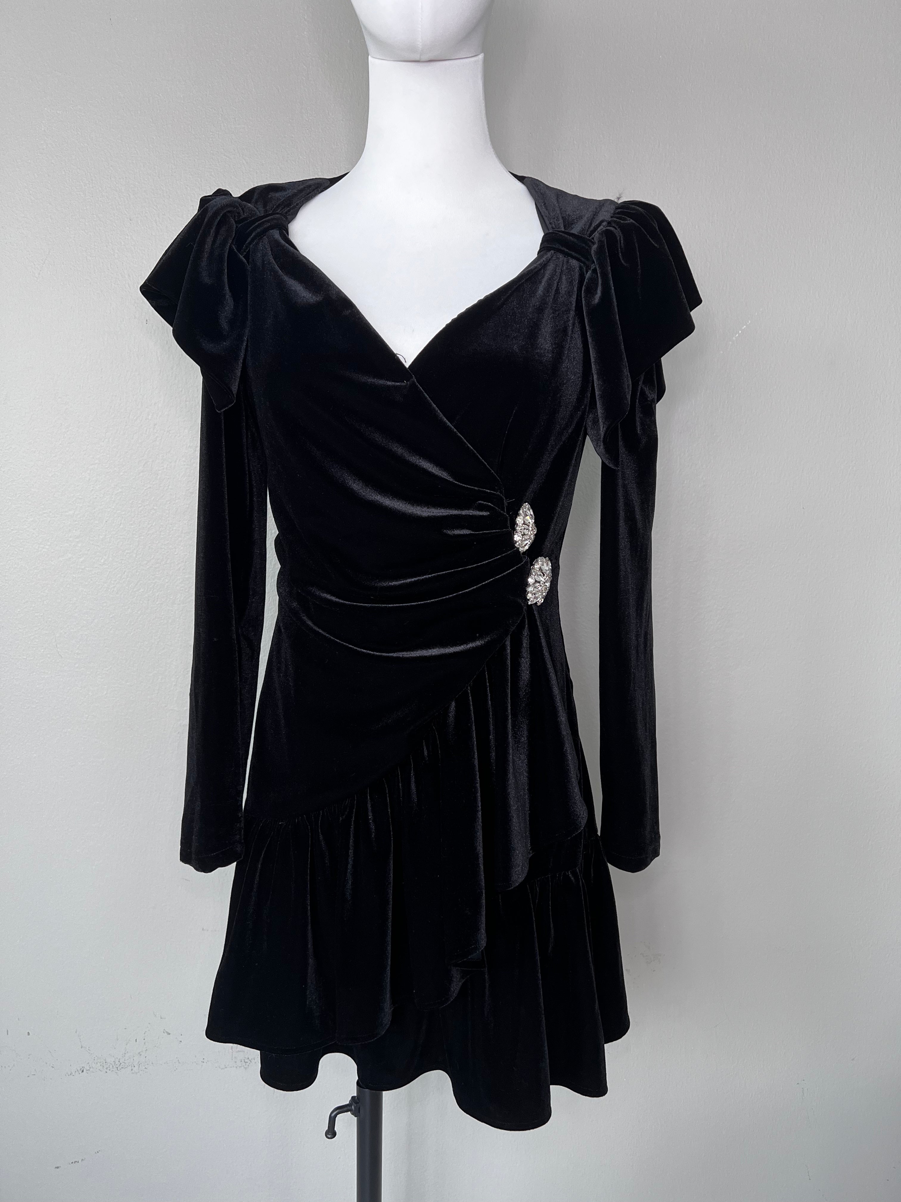 Short black velvet dress with deep v and Swarovski jewels on the side.