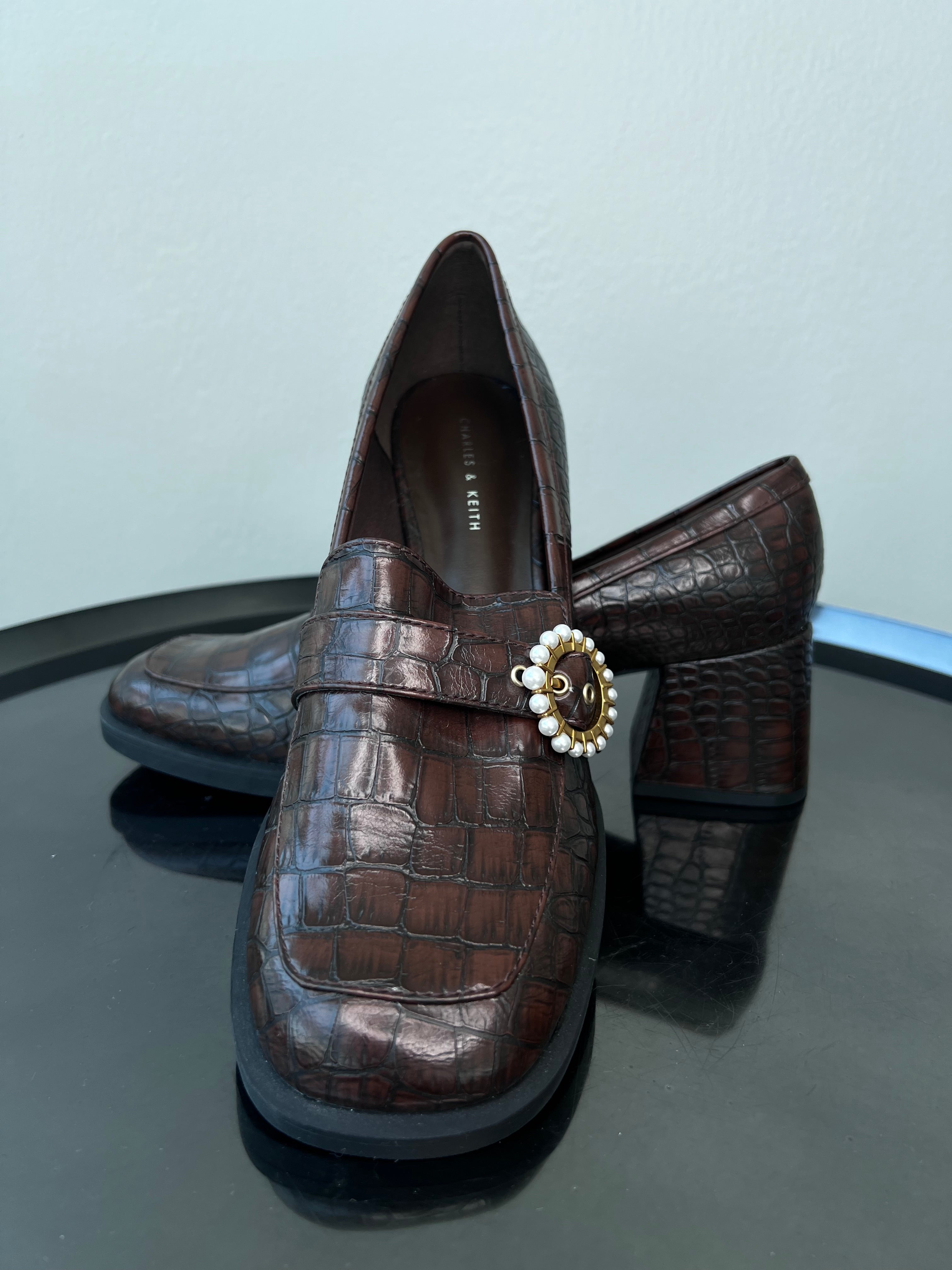 Brown leather heeled loafers with pendant. - CHARLES AND KEITH