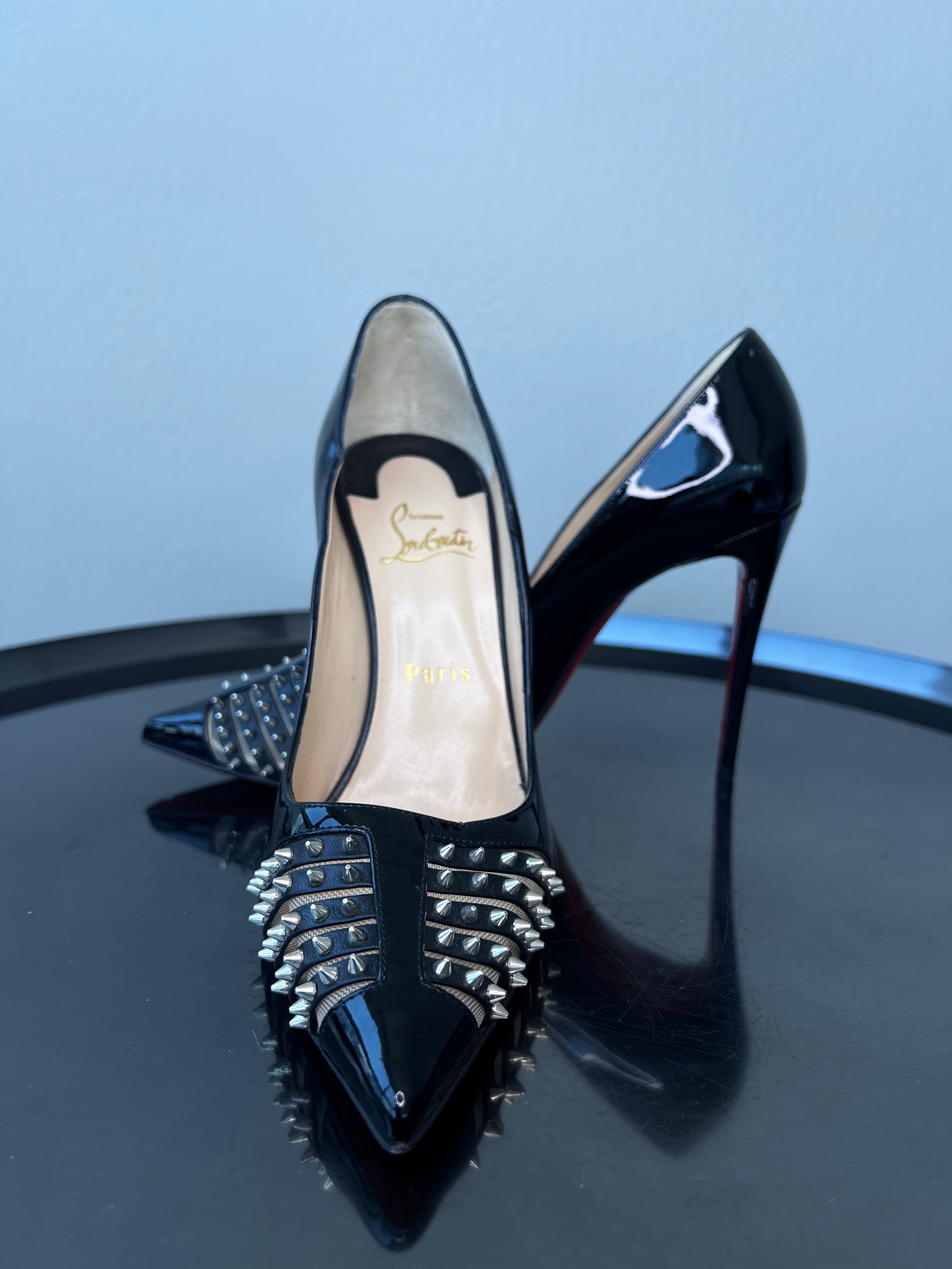Shiny black pointed toe stiletto heel with studs at the front. - CHRISTIAN LOUBOUTIN